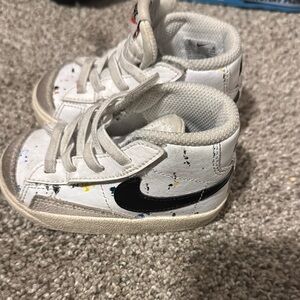Nike Kids White Sneakers with Black Swoosh paint splatter